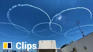 Japanese fighter pilots draw Olympic rings over Tokyo in practise flight ahead of Games