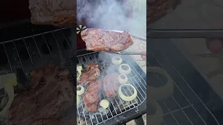 Grilling Strip Steaks Cooking over Charcoal