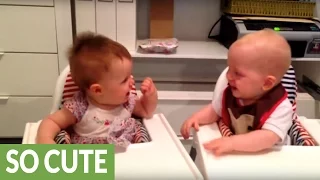 Twin babies engage in hysterical giggling fit