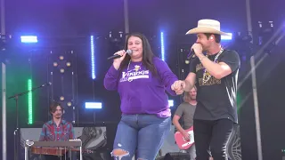 Dustin Lynch performing "Thinking 'Bout You" with binging a fan named Kayla on stage!
