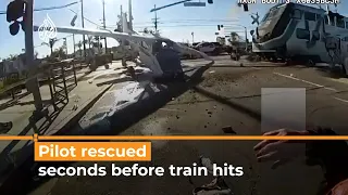 Pilot of crashed plane rescued seconds before train hits | AJ #shorts