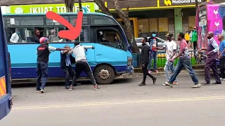 Two Matatu bus drivers fight in the middle of Nairobi city CBD, Kenyatta Avenue.