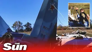 Ukrainian troops rip apart downed Russian jet