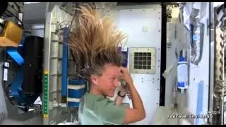 Astronaut Karen Nyberg, demonstrates hair washing in space