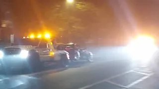 2 Tow Trucks towing Vehicles going by with lights