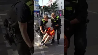 Car drives through eco protesters and police remove activists by the neck