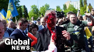 Russian ambassador doused in red paint by Ukraine war protesters in Poland