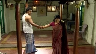 Selvam holds Archana's hand