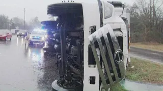 Powerful winds flip over US Postal Service truck