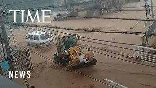 Family of Three Rescued in Beijing Flooding That Left At Least 20 Dead, Dozens Missing