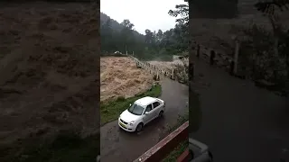 Brave drivers crossing bridge during dangerous flood