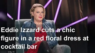 Eddie Izzard cuts a chic figure in a red floral dress at cocktail bar