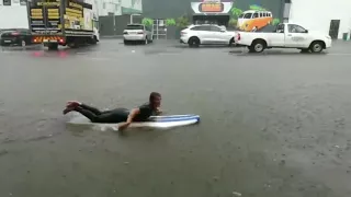 Surfer Takes to the Flooded Streets of Durban