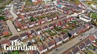 Aerial video shows houses partially submerged by flood water after torrential rainfall