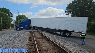 Semi bottoms out on RR crossing, NS 288 gets stopped before impact.
