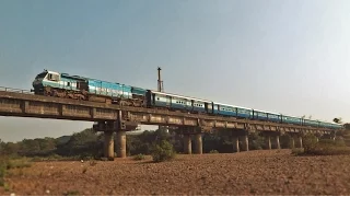 Original EMD Monster with the FOOD KING Mandovi Express over a beautiful river bridge!