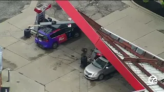 Gas station canopy collapses onto pump, cars causing fire in Farmington Hills