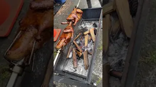Spit roasting duck n chicken for dinner on open fire