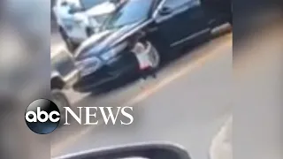 Toddler emerges from truck with her hands up as she walks towards police