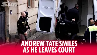 Andrew Tate smiles leaving court after British cops issue arrest warrant over flee fears