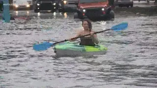 Kayakers paddle down flooded New Orleans streets