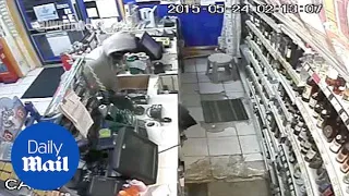 CCTV shows two men burst into corner shop with MACHETE - Daily Mail