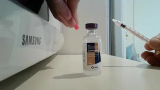 Diabetic dog - drawing up insulin into a syringe.