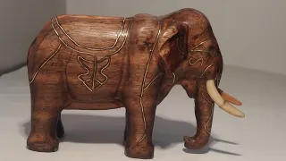 wooden elephant with brass inlay