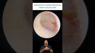 WRAPPING PAPER REMOVAL FROM CHILDS EAR