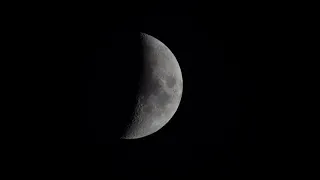 Moon in the black sky, visibility 40 percent, focal length 1260mm, 4K