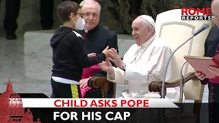 Child spontaneously climbs on stage to ask Pope Francis for his cap