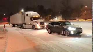 Electric Tesla Model X Towing a Semi Truck Stuck in the Snow