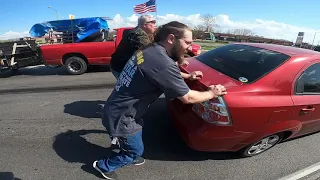 Bikers Helping Push Car Out Of Traffic