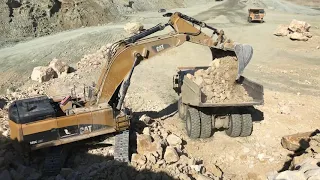 Caterpillar 385C Excavator Loading Rocks On Dumpers - Labrianidis SA