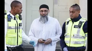 Anjem Choudary appears before media on steps of probation hostel