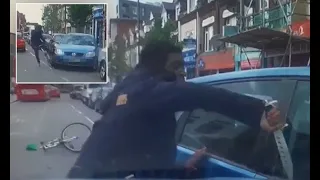 Terrifying moment cyclist armed with a huge 'zombie knife' tries to smash motorist's window