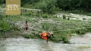 Watch: firefighters rescue trapped man in flood