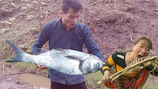 Couple hunting and fishing and cook grilled fish