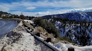 Driving along snow covered Highway 18 Rim of the World Scenic Byway to Big Bear Lake