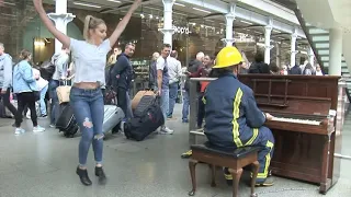 Fireman Lifts Girl To The Piano and Astounds The Whole Station