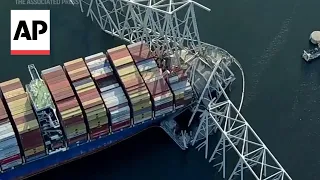 Aerial footage shows crane working on wreckage of Baltimore bridge collapse