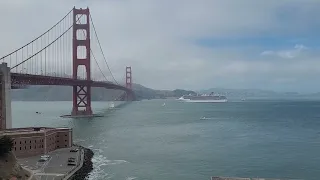 Cruise ship passing under Golden Gate Bridge