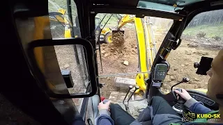 JCB 8085 excavator ripping and moving rocks - cab view