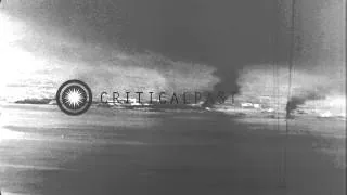 US Navy TBF Avengers in flight as smoke rises from targets in the Pacific Theater...HD Stock Footage
