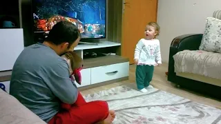 Baby Jealous of the Toy in His Father's Lap