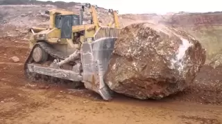 Caterpillar D11R pushing another massive rock