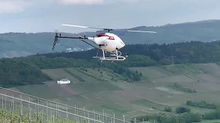 Unmanned drone-helicopter spraying in vineyard in Absurdistan