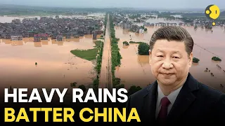 China Floods: Soldiers trek miles to deliver relief supplies to flood-stranded Beijing villagers