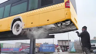 Cleaning Dirty Mercedes City Bus On Massive hydraulic Lift