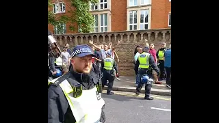 West ham fans get escorted past a Chelsea pub